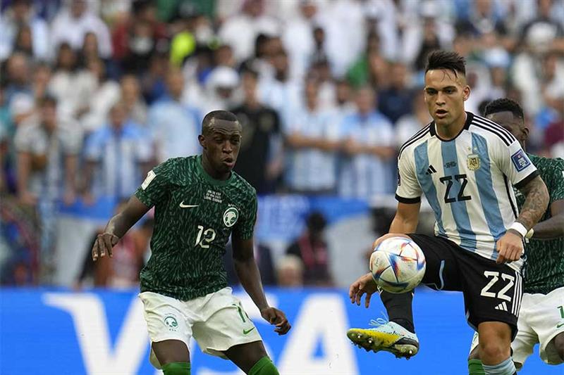 Argentina s Lautaro Martinez, right, kicks the ball during the World Cup group C soccer match betwee