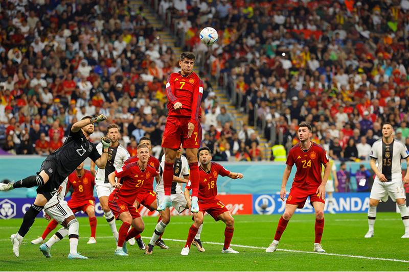 Spain s forward #07 Alvaro Morata (C) jumps to head the ball during the Qatar 2022 World Cup Group E