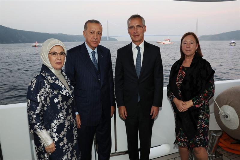 Turkish President Recep Tayyip Erdogan (C-L) and his wife Emine Erdogan (L) posing for a photo with 
