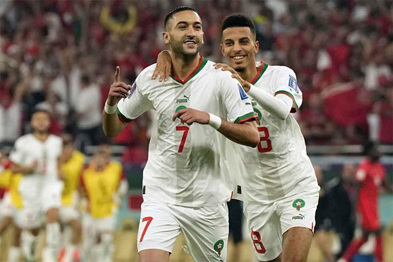 Morocco s Hakim Ziyech, foreground, celebrates after scoring his side s opening goal besides team ma
