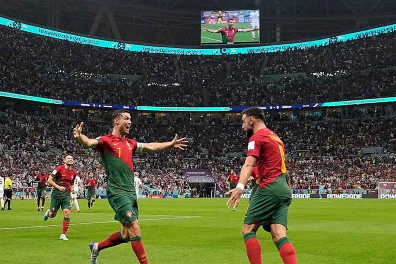 Portugal s Cristiano Ronaldo celebrates his side s opening goal with Portugal s Bruno Fernandes duri