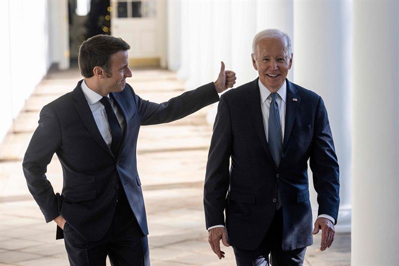 US President Joe Biden and French President Emmanuel Macron walk down the Colonnade at the White Hou