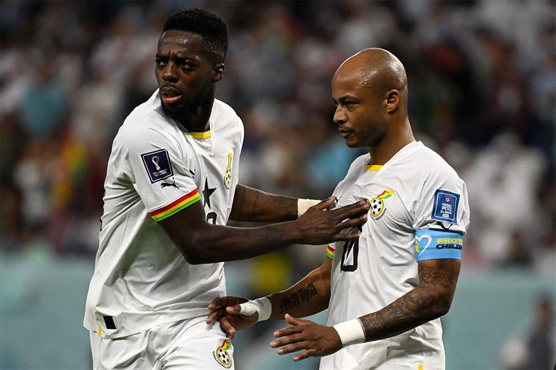 Ghana s midfielder #10 Andre Ayew reacts after missing a goal from the penalty spot next to Ghana s 