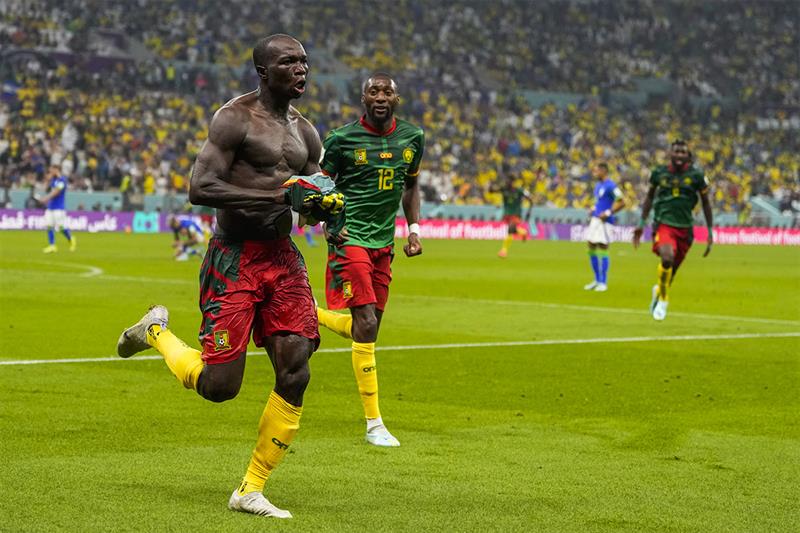 Cameroon s Vincent Aboubakar, left, celebrates after scoring the opening goal during the World Cup g