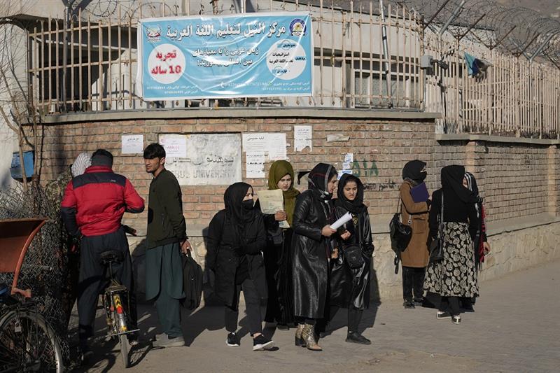 Afghan women students stand outside the Kabul University in Kabul, Afghanistan