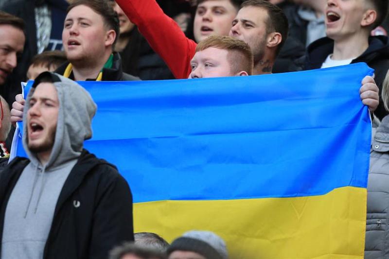 A fan holds up the flag of Ukrainian during the English Premier League football match between Manche