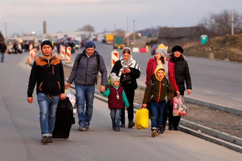 Refugees fleeing conflict in neighboring Ukraine arrive to Przemysl, Poland, Saturday, Feb. 26, 2022