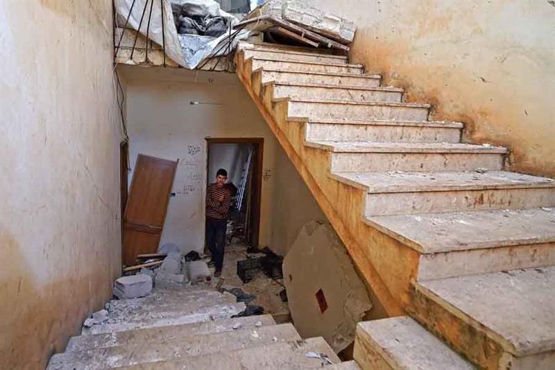 A Syrian boy walks on February 3, 2022 at the scene following an overnight raid by US special operat