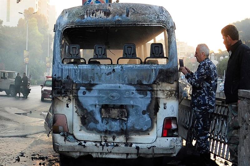 Burned military bus in Syria