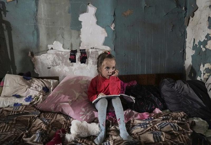 A girl sits in the improvised bomb shelter in Mariupol, Ukraine, Monday, March 7, 2022. AP 