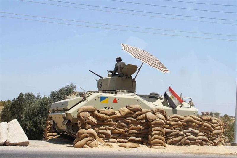 FILE PHOTO: An Egyptian army vehicle keeps its position close to the Rafah border crossing.  AFP
