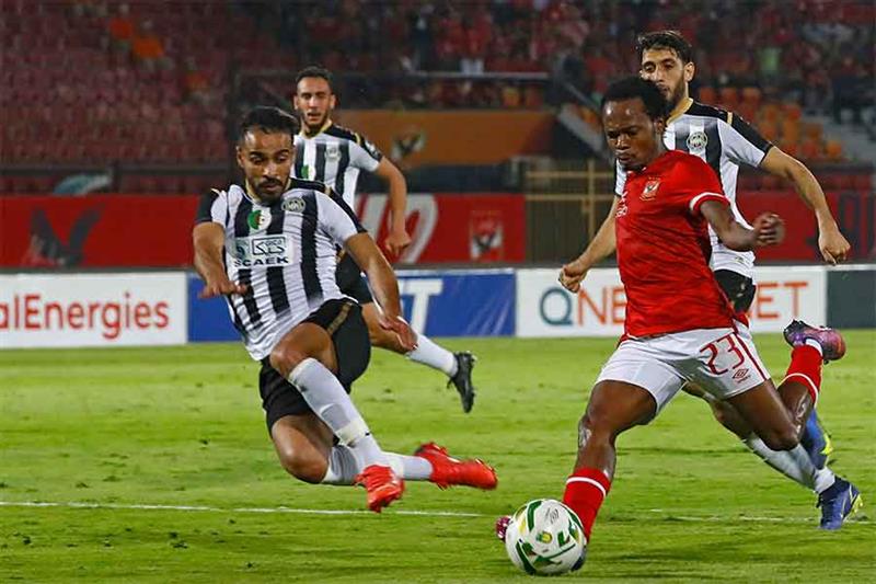 Ahly s forward Percy Tau (R) kicks the ball to score the fourth goal during the CAF Champions League