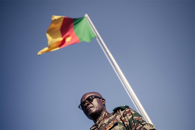 File photo: A Cameroonian general stands by a national flag, in Buea, 26 April 2018. AFP