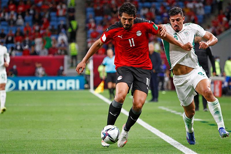 File photo: Algeria s forward Baghdad Bounedjah (R) vies for the ball with Egypt s defender Ahmed He