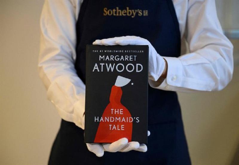 An art handler holds Margaret Atwood s Unburnable Book, a fireproof edition of her prescient and oft