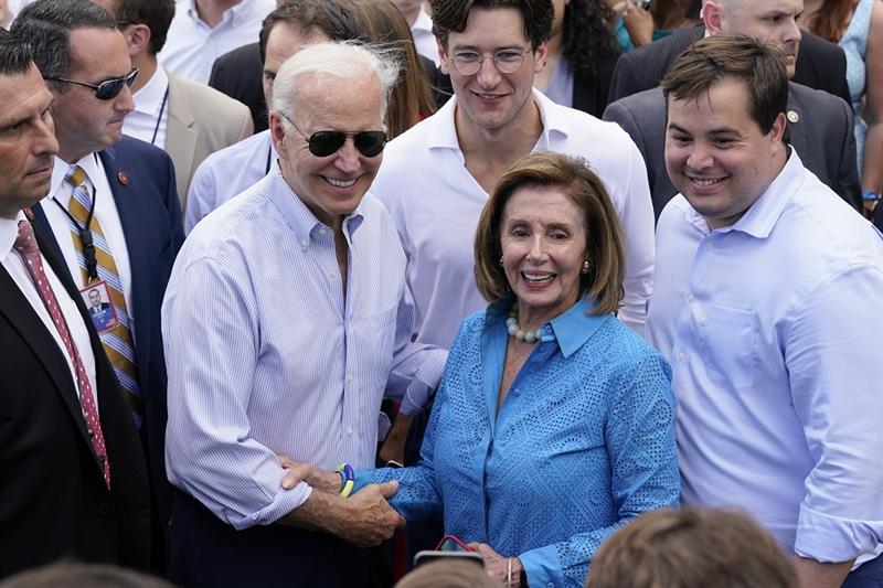President Joe Biden poses for a photo with House Speaker Nancy Pelosi