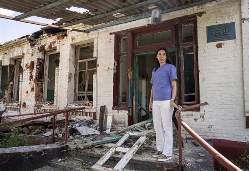 Dr. Ilona Butova stands in front of the therapy department which was destroyed after a Russia attack