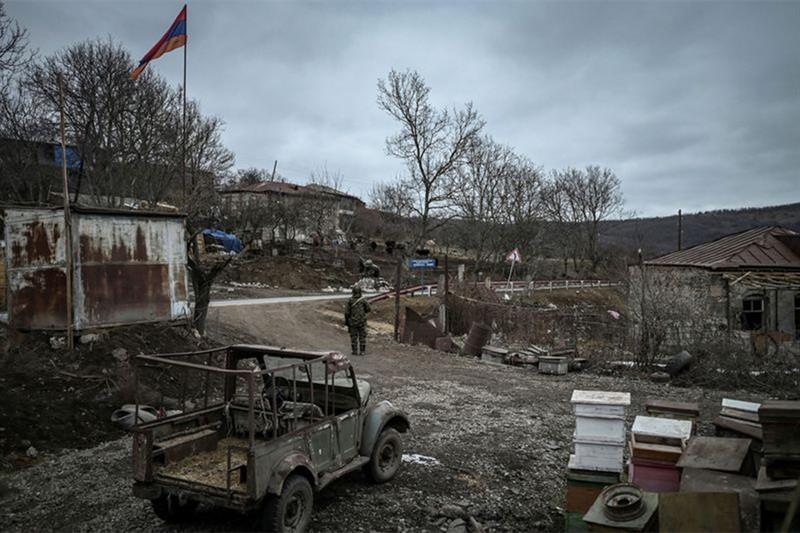 An Armenian soldier stands guard in the village of Shurnukh on the Armenia-Azerbaijan border on Marc
