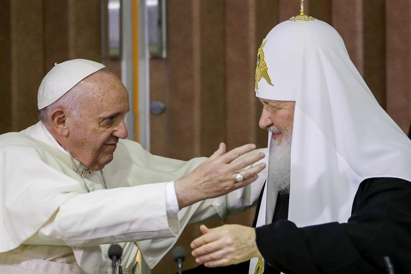Pope Francis, left, reaches to embrace Russian Orthodox Patriarch Kirill