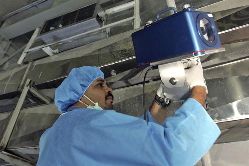 An inspector of the International Atomic Energy Agency sets up surveillance equipment, Iran 