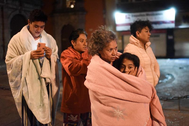 Residents stand in a street after a 6.8-magnitude earthquake in Mexico City 