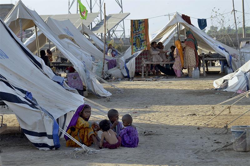 Children play outside their tent at a relief camp, in Jaffarabad, a district in the southwestern Bal