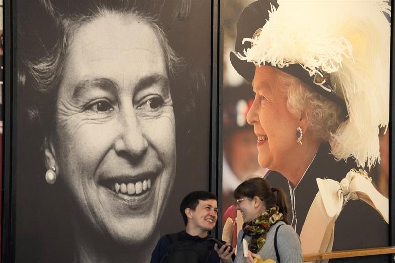 Queen Elizabeth II posters at Buckingham Palace in London, UK