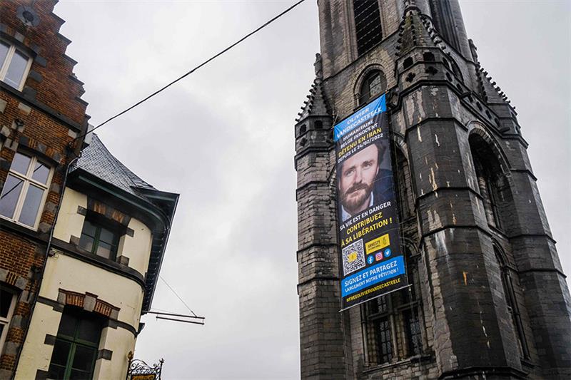 This photograph taken in Tournai on January 12, 2023 shows a giant banner with a portrait of Belgian