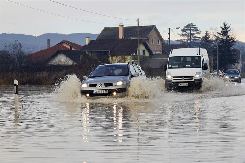 Cars drive through flooded street in the central city of Cacak, 150 kilometers (95 miles) south of B