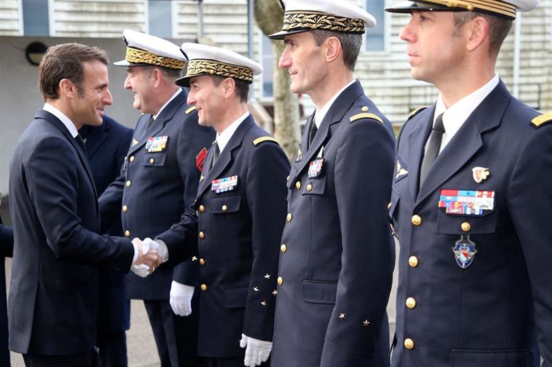 French President Emmanuel Macron shakes hands with officials before his New Year address to the Fren