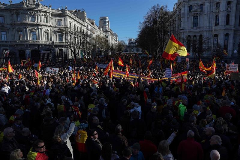 Protesters wave Spanish national flags as they gather during an anti-government demonstration called