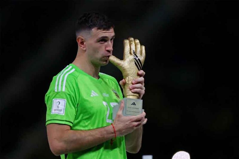 Argentina s Emiliano Martinez after he is awarded the golden glove award during the trophy ceremony 