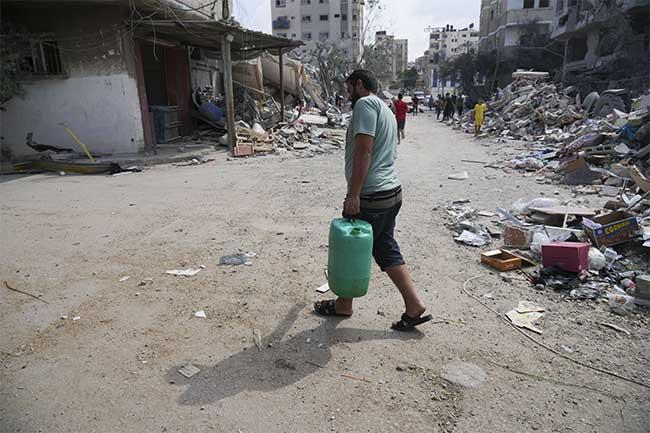 A Palestinian carries a water 