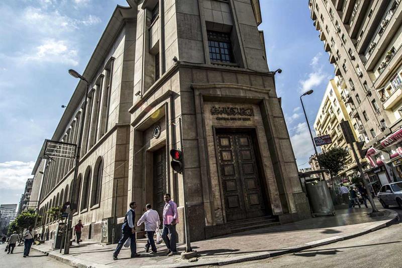 file photo people walk past the Egyptian Central Bank in downtown Cairo on . AFP