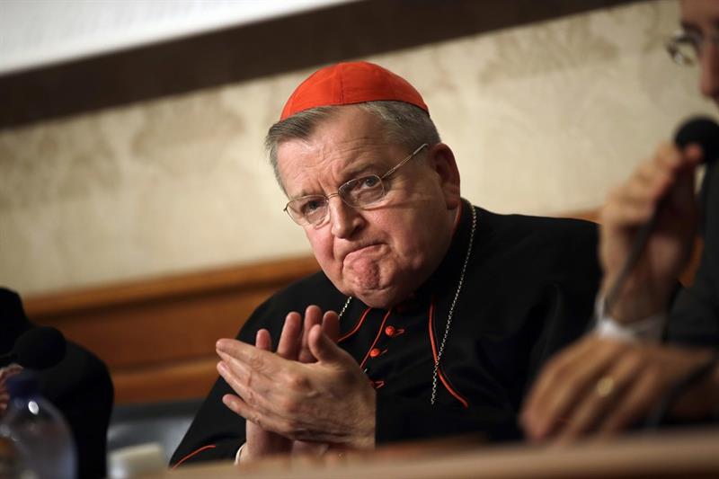 Cardinal Raymond Burke applauds during a news conference at the Italian Senate, in Rome. 