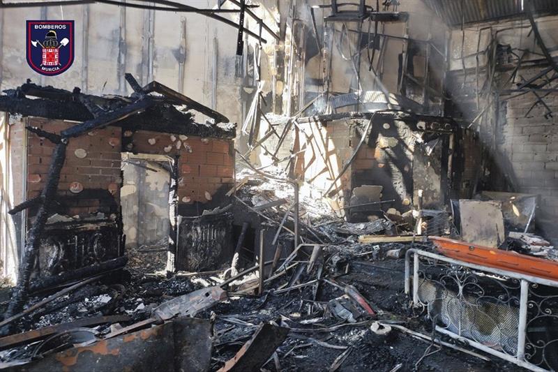 In this photo provided by Bomberos/ayuntamiento de Murcia, part of the burned-out interior a nightcl