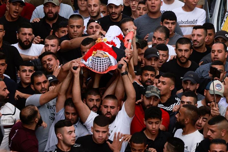 Mourners carry the body of Usayed Hmaidat, a Palestinian youth killed during during a reported Israe
