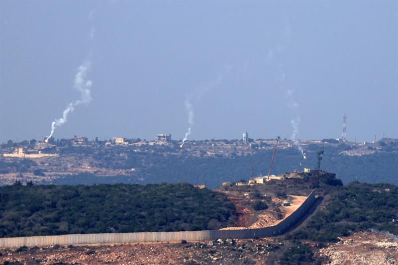 Flares are fired from northern Israel over the southern Lebanese border village of Aita al-Shaab, on