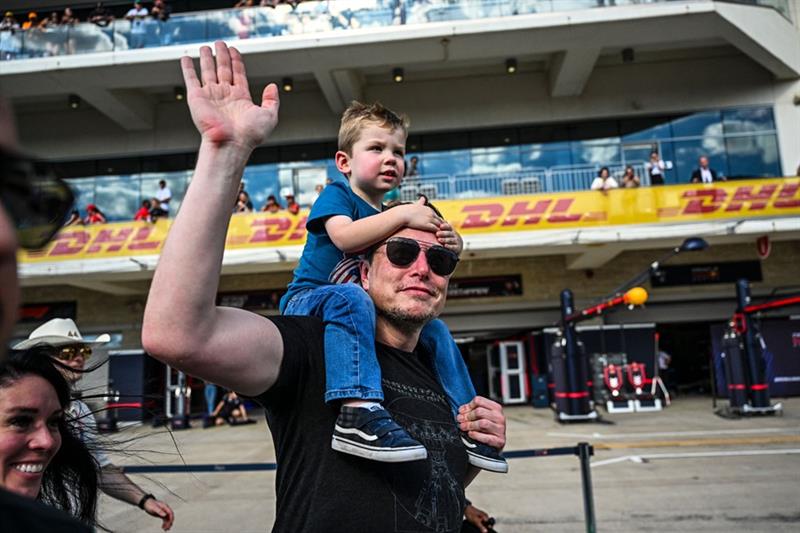 SpaceX CEO Elon Musk with one of his son walks on the pit lane after the 2023 United States Formula 