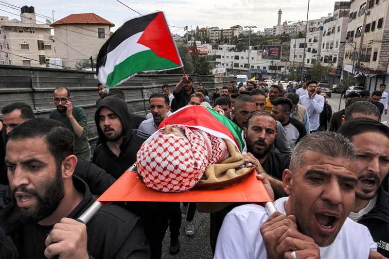 Mourners carry the body of Issa al-Qadi, a 66-year-old Palestinian man who was shot dead reportedly 