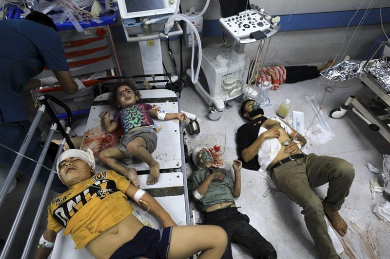 Palestinians wounded in the Israeli bombardment wait for treatment in Shifa Hospital in Gaza City, M
