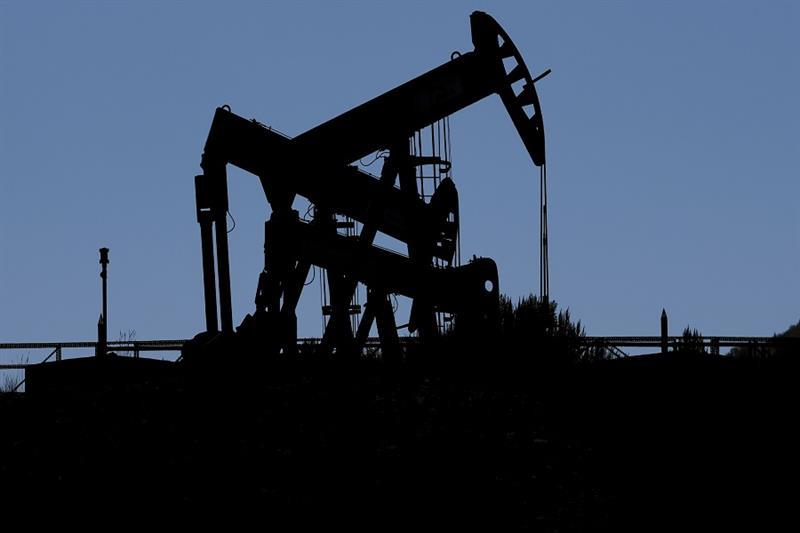 Pumpjacks dip their heads to extract oil in a basin south of Duchesne, Utah on Thursday, July 13, 20