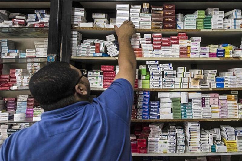 File Photo: A pharmacy employee reaches out to grab a box of medicine in a pharmacy, Cairo, Egypt. A