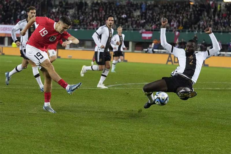 Germany s Antonio Rudiger, right, defends against a shot by Austria s Christoph Baumgartner during t