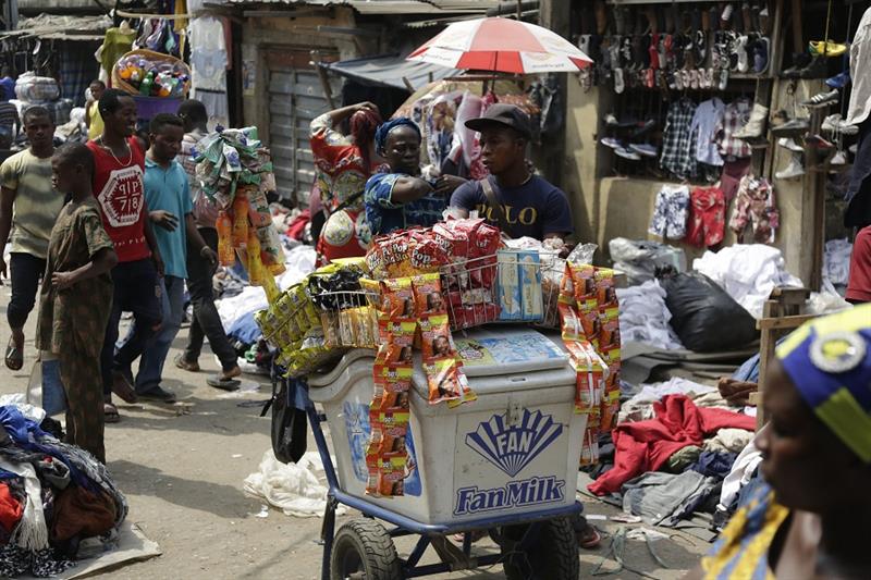 Pedestrians shop in a roadside market in Lagos, Nigeria. AP Photo.