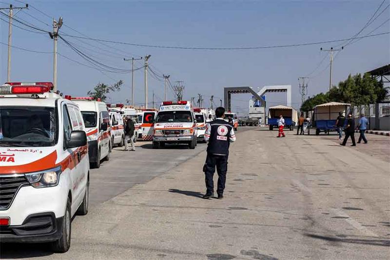 Palestinian health ministry ambulances cross the gate to enter the Rafah border crossing in the sout