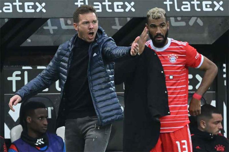 Bayern Munich s German head coach Julian Nagelsmann (L) reacts next to Bayern Munich s Cameroonian f