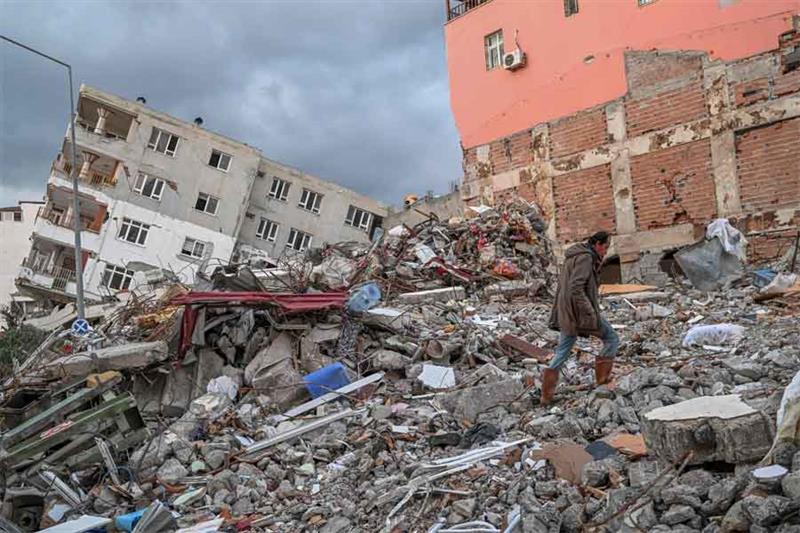 Aytekin Mumoglu, 46, climbs the rubble at the place where his house was, a day after a 6.4-magnitude