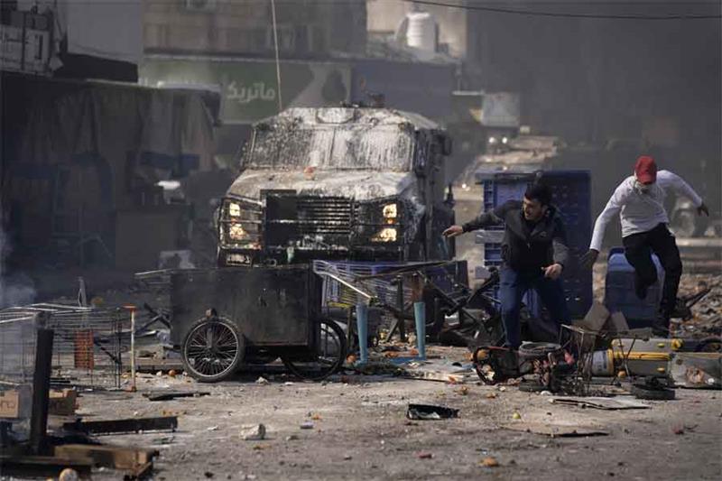Palestinians clash with Israeli forces in the West Bank city of Nablus, Wednesday, Feb. 22, 2023.  A