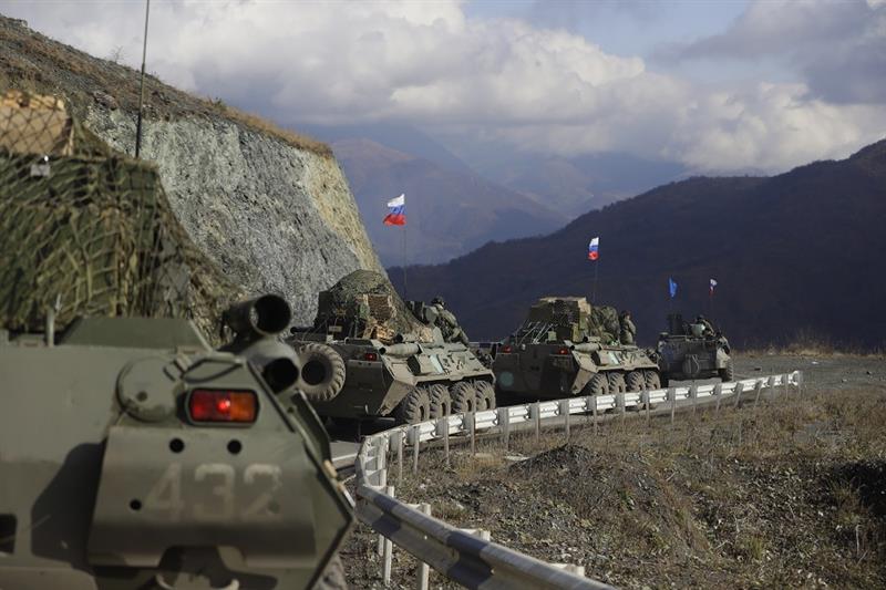 Russian military vehicles roll along a road towards the separatist region of Nagorno-Karabakh, 